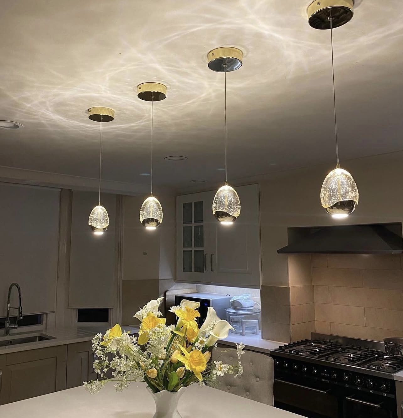 Glass pendant lighting installed in a Cobham kitchen