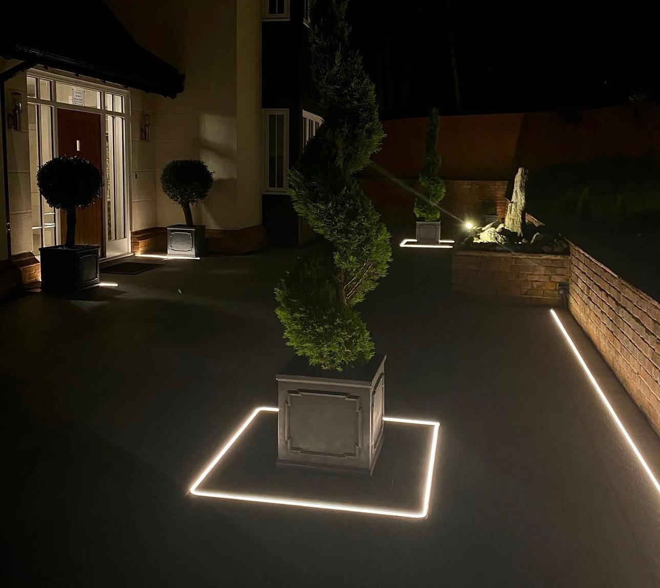 Outdoor LED strip lighting illuminating driveway and planters in Surrey